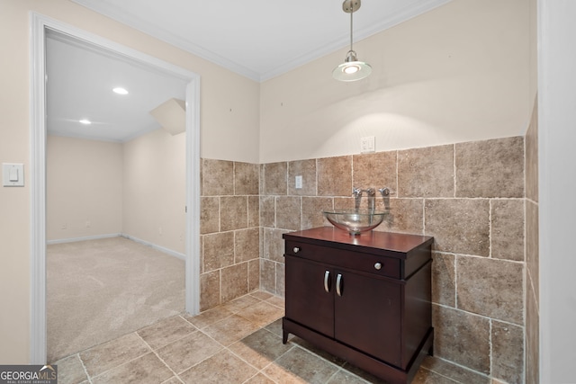bathroom featuring wainscoting, vanity, tile walls, ornamental molding, and recessed lighting