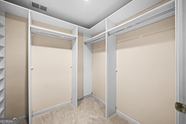 walk in closet featuring carpet floors and visible vents