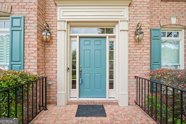 view of exterior entry with brick siding