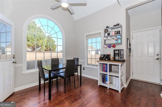 dining room with vaulted ceiling, baseboards, ceiling fan, and dark wood finished floors