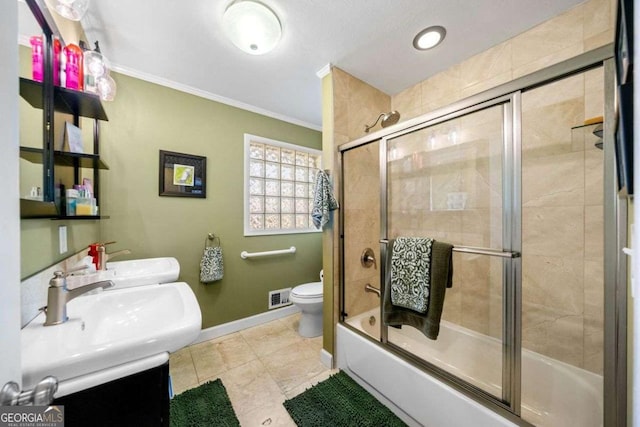 1505 Robinhood Trl, Gainesville, GA 30501 - bathroom with ornamental molding, bath / shower combo with glass door, double vanity, and tile patterned floors