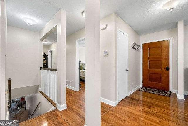 1505 Robinhood Trl, Gainesville, GA 30501 - corridor with an upstairs landing, wood finished floors, and a textured ceiling