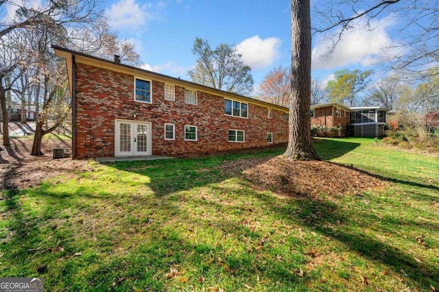 1505 Robinhood Trl, Gainesville, GA 30501 - back of property featuring french doors, brick siding, a lawn, and a sunroom