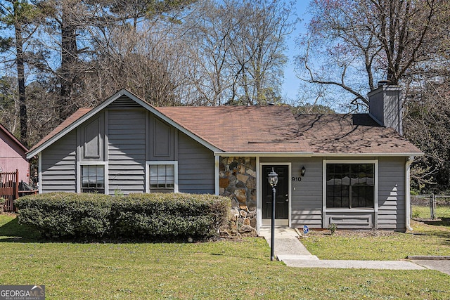 910 Brandon Hill Way, Jonesboro, GA 30238 - view of front of house featuring a chimney, stone siding, and a shingled roof