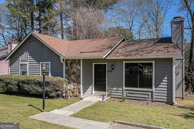 910 Brandon Hill Way, Jonesboro, GA 30238 - view of front facade with a chimney, a front lawn, stone siding, and a shingled roof