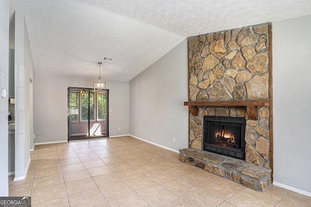910 Brandon Hill Way, Jonesboro, GA 30238 - unfurnished living room featuring a textured ceiling, a fireplace, lofted ceiling, baseboards, and light tile patterned floors