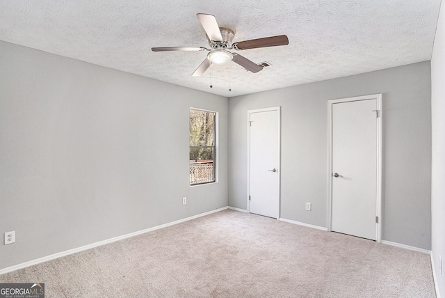 910 Brandon Hill Way, Jonesboro, GA 30238 - unfurnished bedroom featuring carpet floors, a textured ceiling, baseboards, and a ceiling fan