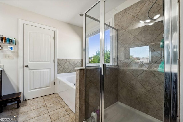 full bath with a bath, vanity, tile patterned floors, and a shower stall