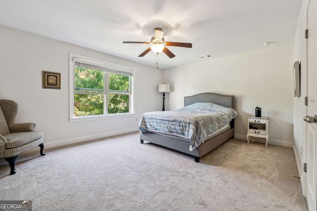 carpeted bedroom featuring baseboards, ceiling fan, and visible vents