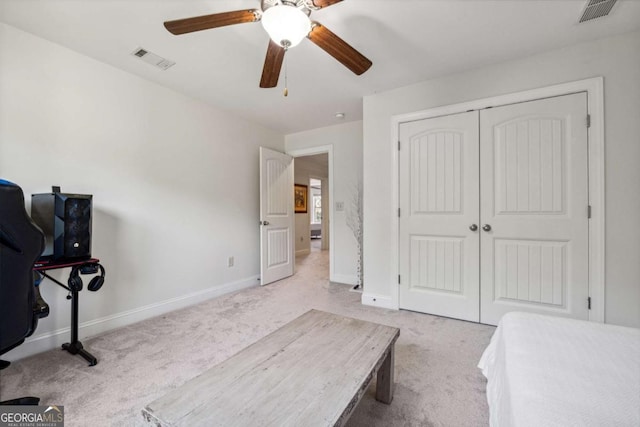 bedroom with baseboards, a closet, light colored carpet, and visible vents