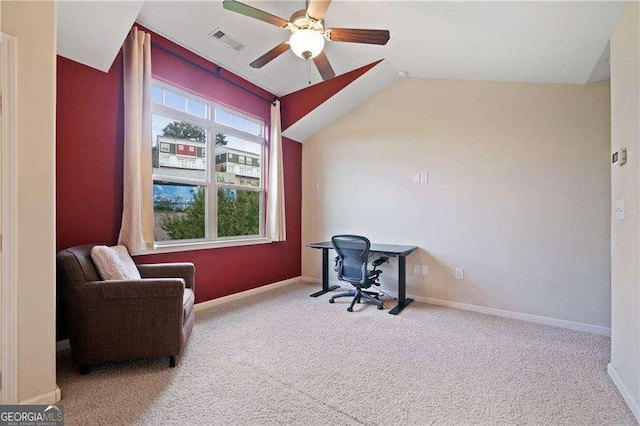 carpeted office space featuring baseboards, visible vents, vaulted ceiling, and a ceiling fan