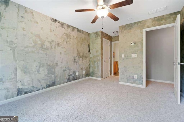 unfurnished bedroom with carpet flooring, baseboards, wallpapered walls, ceiling fan, and visible vents