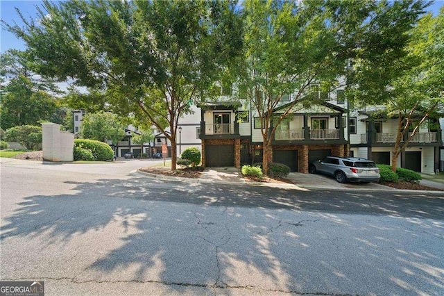 townhome / multi-family property featuring driveway and a garage