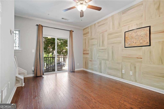 unfurnished room with crown molding, hardwood / wood-style flooring, a ceiling fan, baseboards, and visible vents