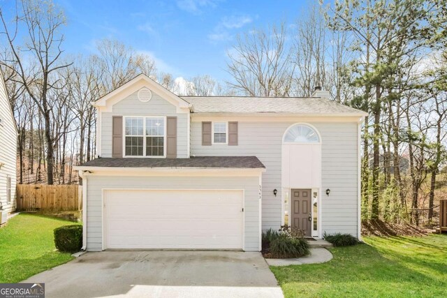3543 Benthollow Way, Duluth, GA 30096 - traditional-style house with concrete driveway, fence, an attached garage, a front yard, and a chimney