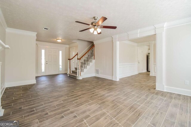 3543 Benthollow Way, Duluth, GA 30096 - entrance foyer featuring stairway, a ceiling fan, a textured ceiling, wood finish floors, and ornamental molding