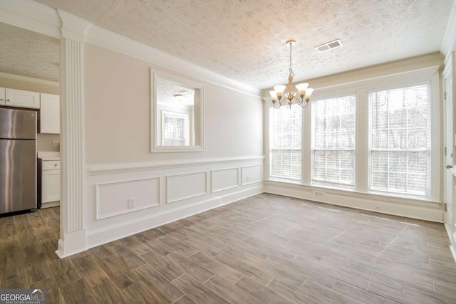 3543 Benthollow Way, Duluth, GA 30096 - unfurnished dining area with visible vents, crown molding, wood finished floors, and a chandelier