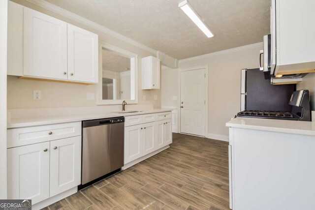 3543 Benthollow Way, Duluth, GA 30096 - kitchen featuring white cabinets, ornamental molding, wood finished floors, appliances with stainless steel finishes, and a sink