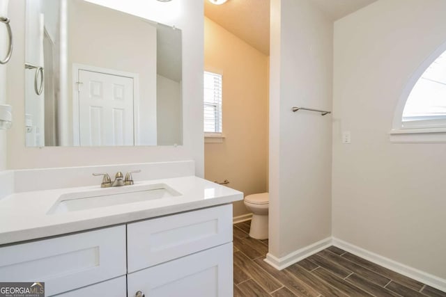 3543 Benthollow Way, Duluth, GA 30096 - bathroom with baseboards, toilet, wood finish floors, and vanity