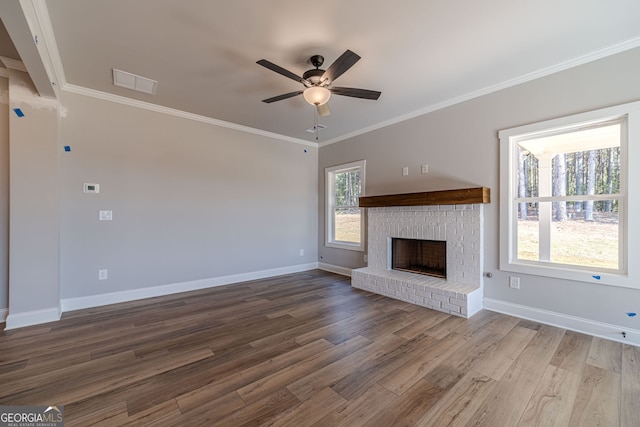 unfurnished living room featuring a ceiling fan, wood finished floors, baseboards, ornamental molding, and a fireplace