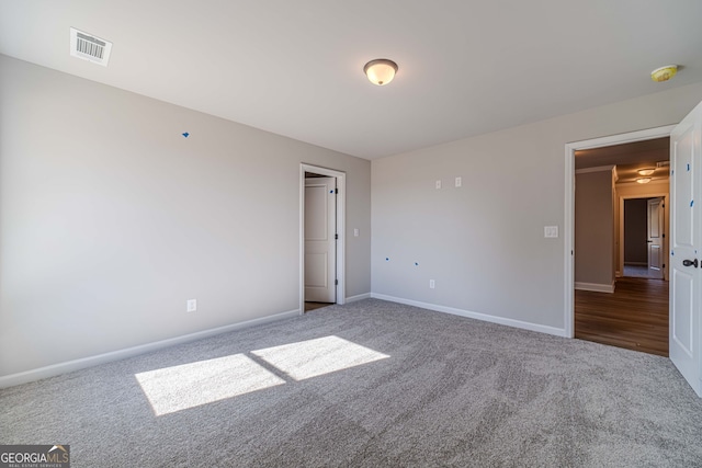unfurnished bedroom with carpet flooring and baseboards