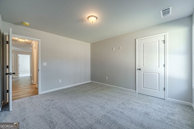 unfurnished bedroom with carpet flooring and baseboards