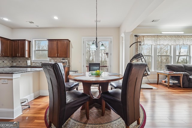 2220 Stirling Bridge Rd, Cumming, GA 30041 - dining area with recessed lighting, visible vents, light wood-style floors, and a notable chandelier