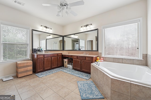 2220 Stirling Bridge Rd, Cumming, GA 30041 - full bath with visible vents, double vanity, a ceiling fan, a sink, and a garden tub
