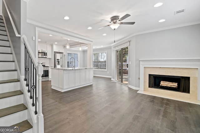 3465 Maple Valley Dr, Cumming, GA 30040 - unfurnished living room featuring a premium fireplace, a ceiling fan, ornamental molding, recessed lighting, and stairs