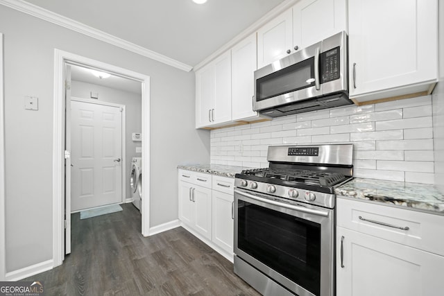 3465 Maple Valley Dr, Cumming, GA 30040 - kitchen featuring appliances with stainless steel finishes, washer / clothes dryer, crown molding, white cabinets, and dark wood-type flooring