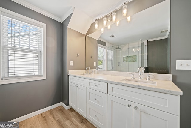 3465 Maple Valley Dr, Cumming, GA 30040 - bathroom with double vanity, a stall shower, ornamental molding, and wood finished floors