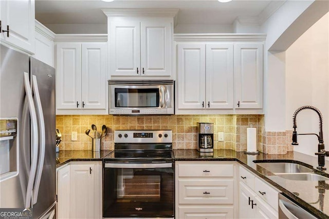 2277 Peachtree Rd NE Unit 608, Atlanta, GA 30309 - kitchen with stainless steel appliances, white cabinetry, dark stone countertops, and tasteful backsplash
