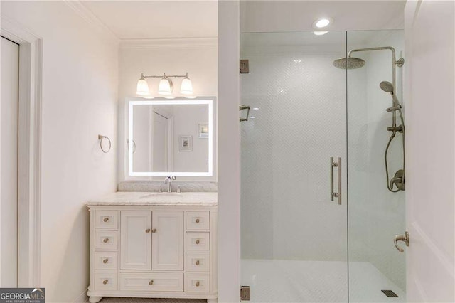 bathroom with vanity, ornamental molding, and a stall shower