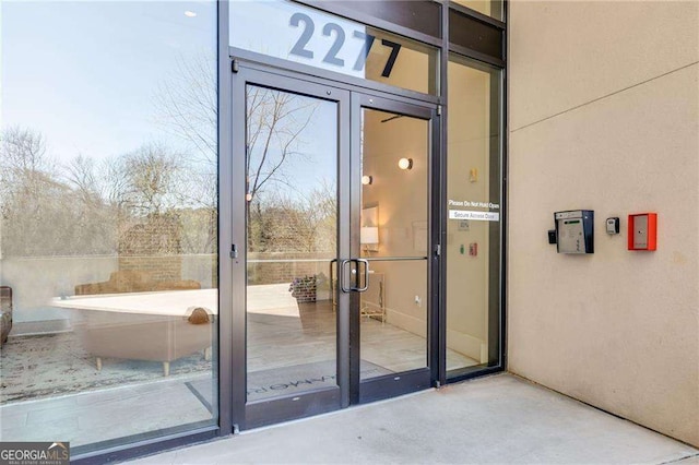 entrance to property featuring stucco siding