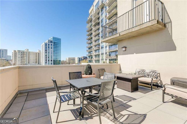view of patio / terrace featuring outdoor dining area and a city view