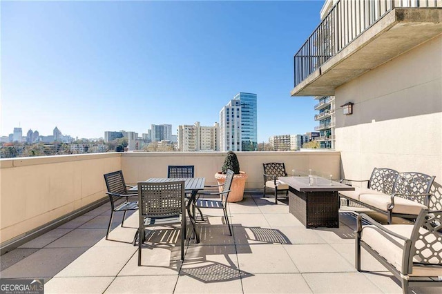view of patio / terrace with an outdoor hangout area, a view of city, and outdoor dining area