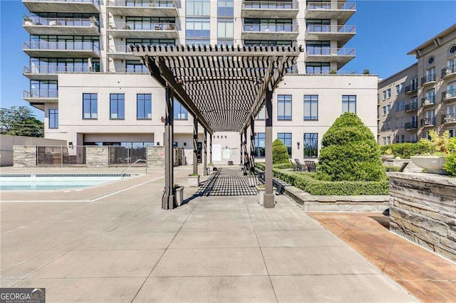 view of community featuring a pergola and fence