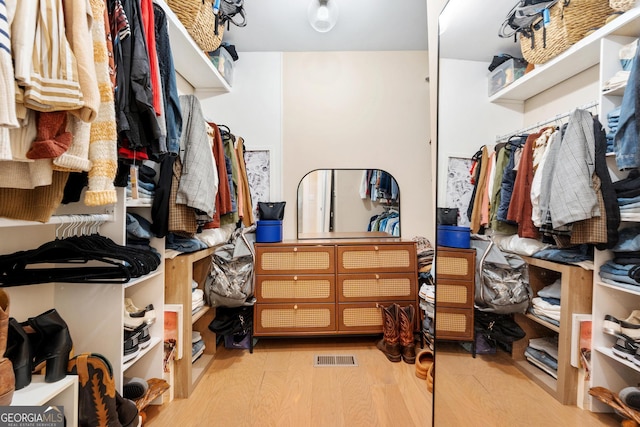 walk in closet with light wood-type flooring