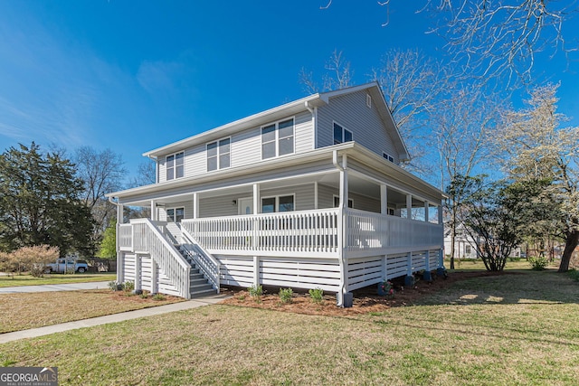 view of front of home featuring a front yard, a porch, and stairway
