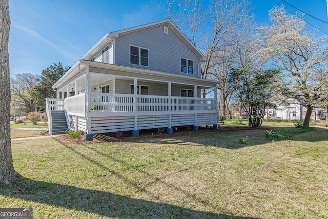 view of front of home with stairs, a porch, and a front yard