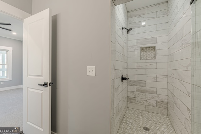 full bathroom featuring a shower stall and baseboards