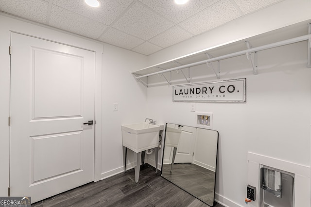 laundry area with dark wood-style floors, baseboards, laundry area, and washer hookup