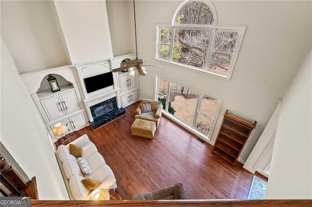 3795 Duckcove Way, Cumming, GA 30041 - living area featuring a towering ceiling, a fireplace, ceiling fan, and wood finished floors