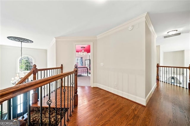 3795 Duckcove Way, Cumming, GA 30041 - hallway featuring an upstairs landing, wood finished floors, a chandelier, crown molding, and baseboards