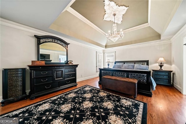 3795 Duckcove Way, Cumming, GA 30041 - bedroom featuring a chandelier, wood finished floors, a tray ceiling, baseboards, and crown molding