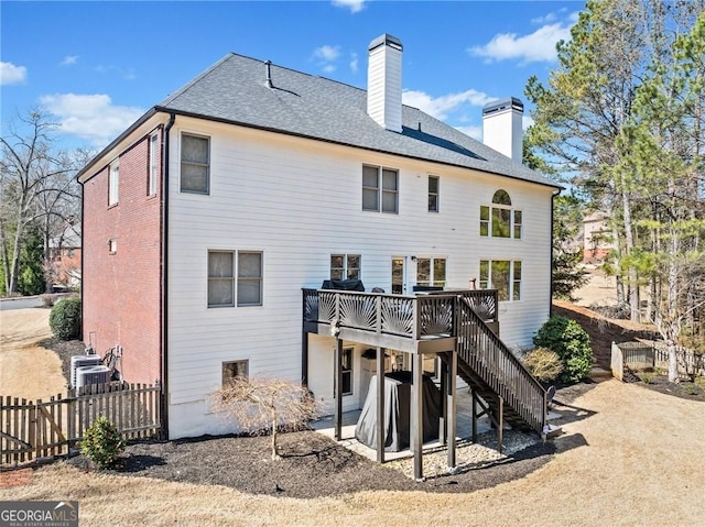 3795 Duckcove Way, Cumming, GA 30041 - back of property featuring a wooden deck, stairway, a chimney, roof with shingles, and a patio area