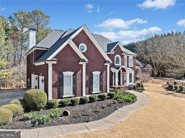 3795 Duckcove Way, Cumming, GA 30041 - view of front facade featuring a garage, brick siding, a chimney, and driveway