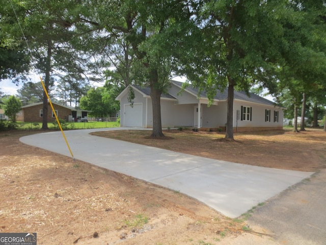 505 Palomino Ln, Warner Robins, GA 31088 - view of side of property featuring concrete driveway and a garage