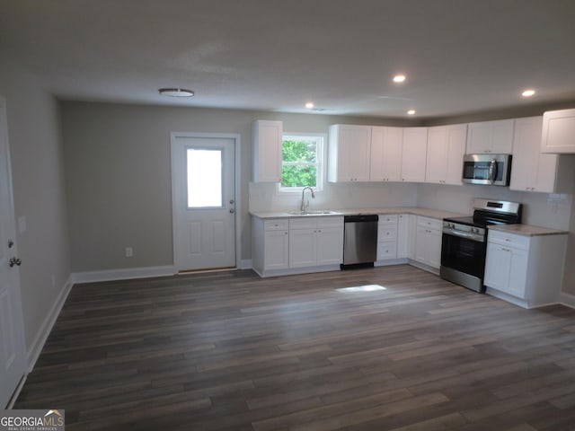 505 Palomino Ln, Warner Robins, GA 31088 - kitchen featuring stainless steel appliances, a sink, white cabinets, light countertops, and baseboards