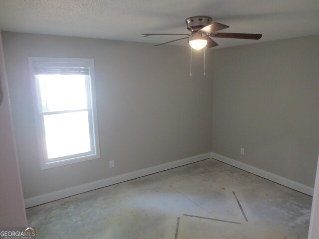 505 Palomino Ln, Warner Robins, GA 31088 - unfurnished room featuring ceiling fan, baseboards, and concrete floors